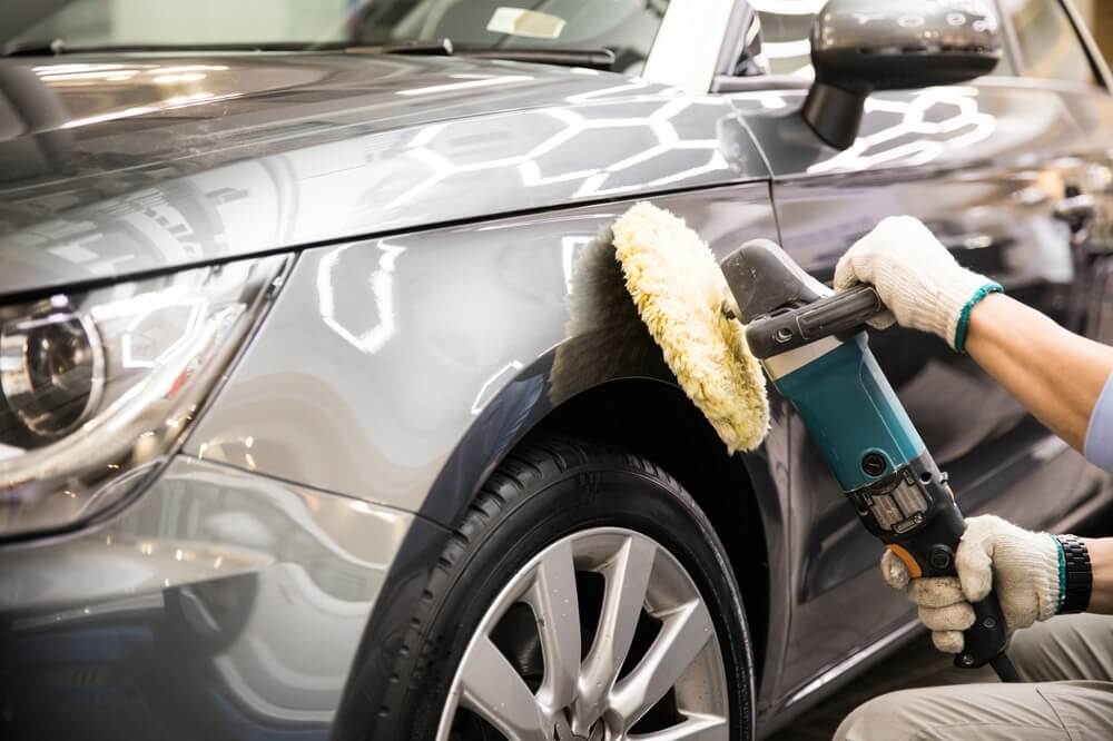 Car Detailing - Expertly polishes a luxury vehicle, creating a glossy shine.