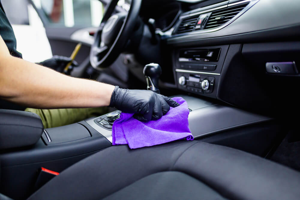 A man cleaning car interior, car detailing (or valeting) concept. 